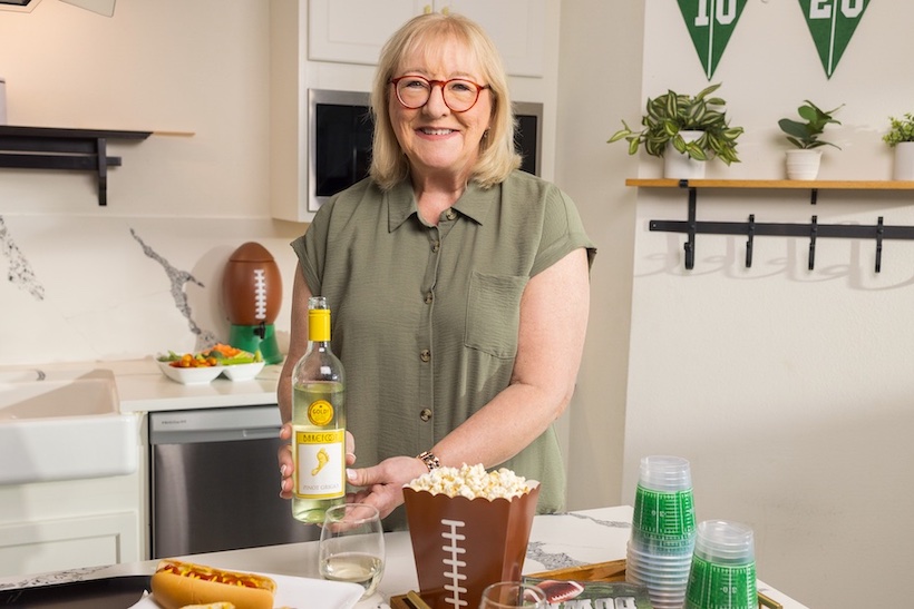 Donna Kelce holding bottle of Barefoot Wine